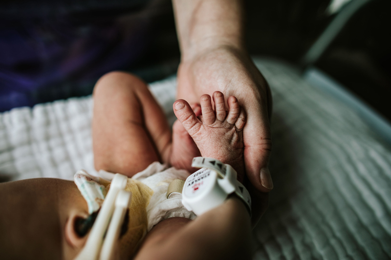 Atlanta Newborn Photographer, hand holds little baby foot in hospital