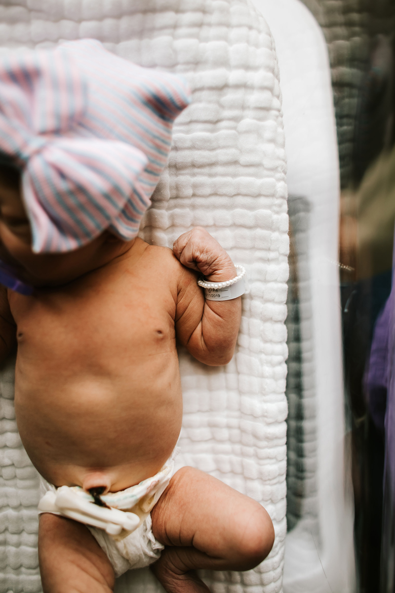 Atlanta Newborn Photographer, newborn baby lays in hospital bassinet