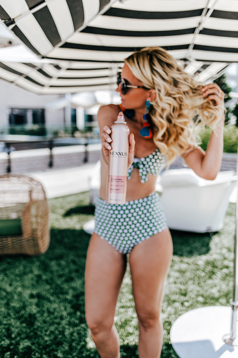 Atlanta Influencer-Blogger Photographer, Blonde woman in polka dot bikini holds out Nexxus Hair Spray