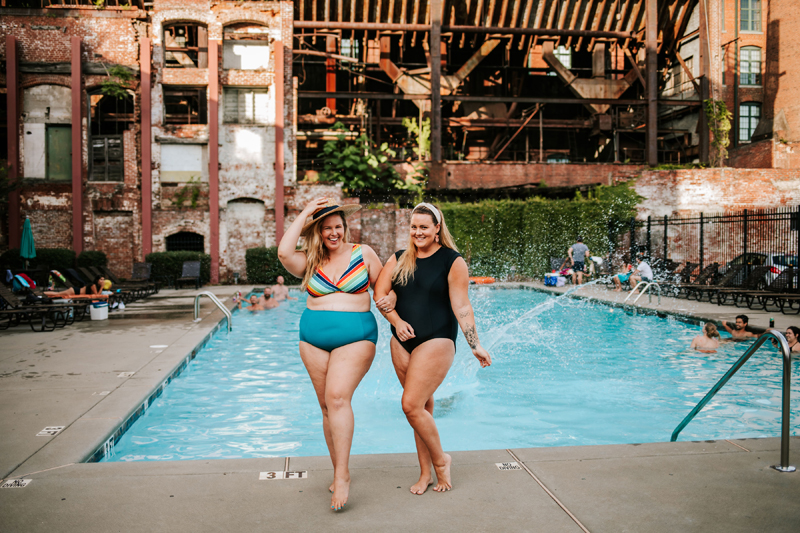 Atlanta Blogger-Influencer Photographer, two women in swimsuits lock arms near the poolside