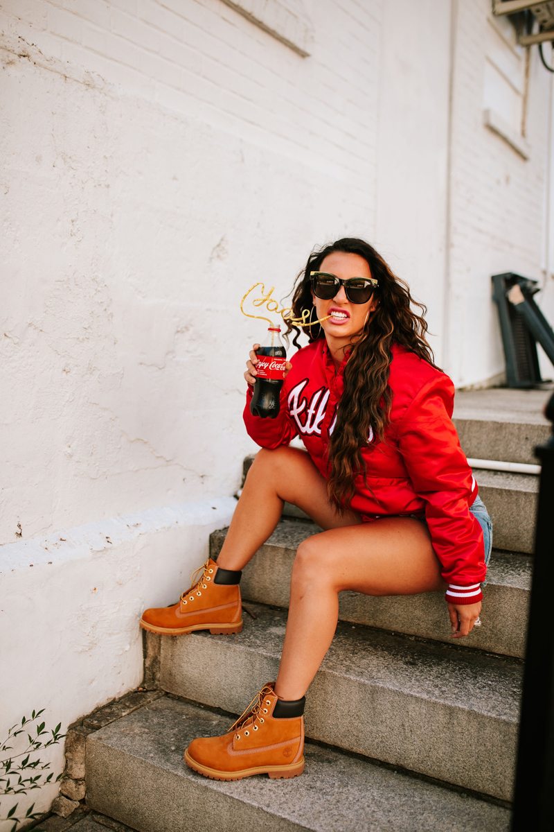 Atlanta Blogger-Influencer Photographer, Woman sits drinking from a coca-cola bottle with a twisted straw