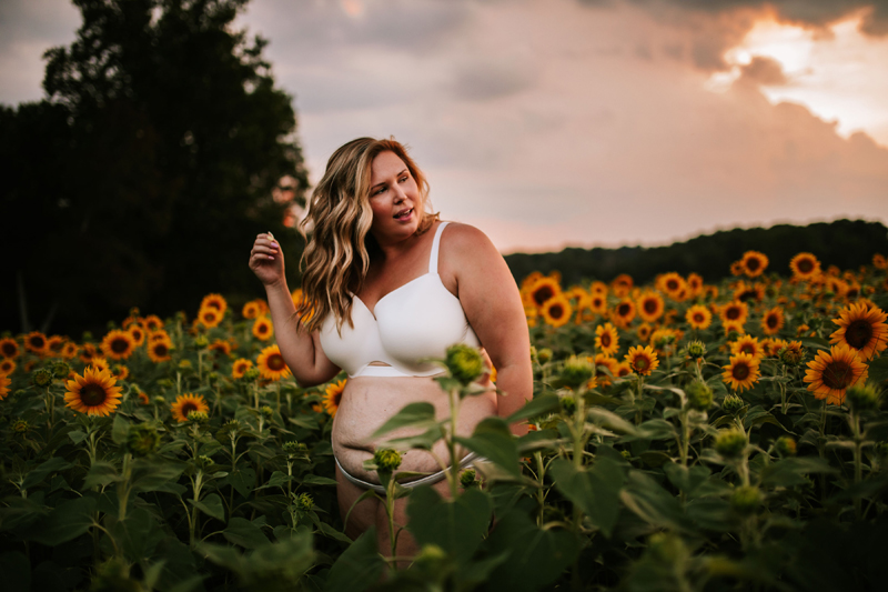 Atlanta Blogger-Influencer Photographer, a woman in a white bra stands in a sunflower field