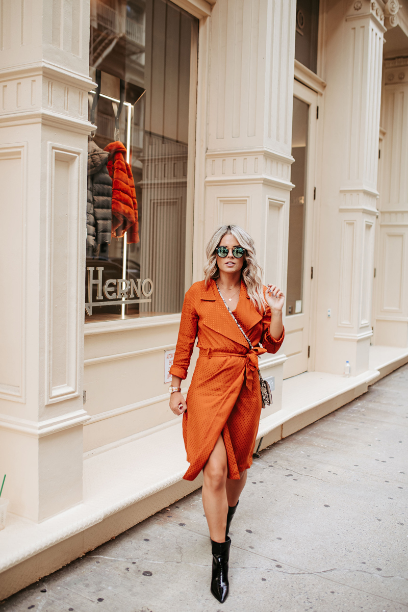 Atlanta Blogger-Influencer Photographer, a woman in an orange jumper and black walks downtown