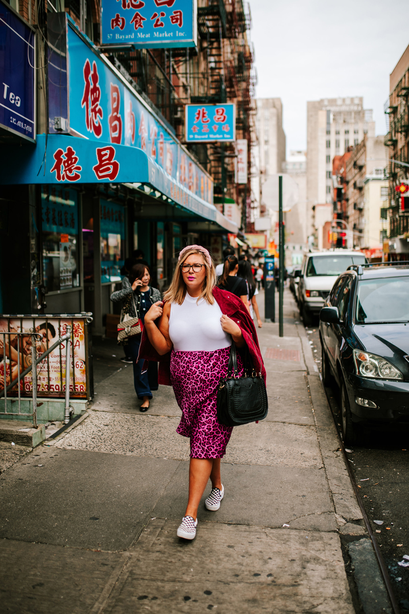 Atlanta Blogger-Influencer Photographer, Woman with pink leopard skirt walks through chinatown