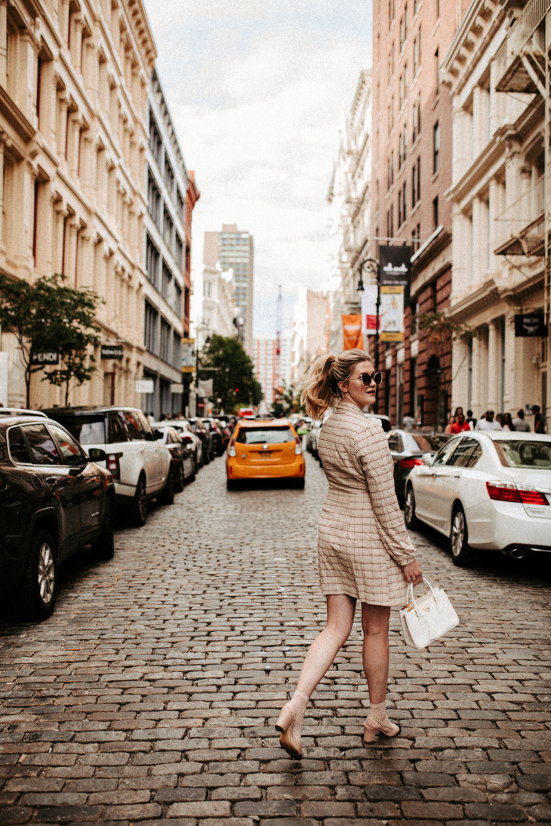 Atlanta Blogger-Influencer Photographer, fashionably dressed woman walks down a busy city street