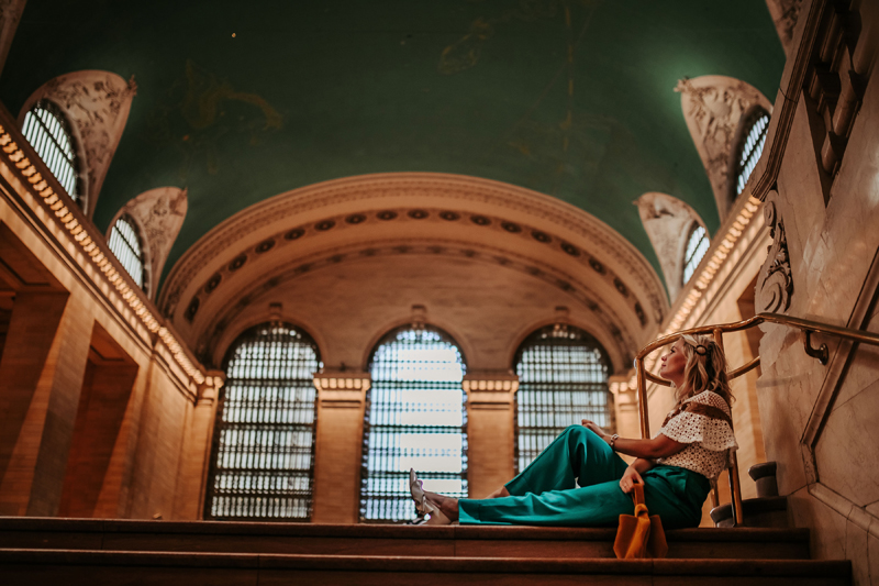 Atlanta Influencer-Blogger Photographer, woman sits near stairs, fashionably dress at museum