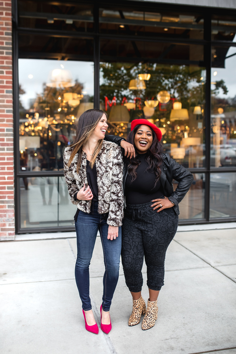 Atlanta Influencer-Blogger Photographer, two friends dressed in floral patterns  laugh near a city storefront