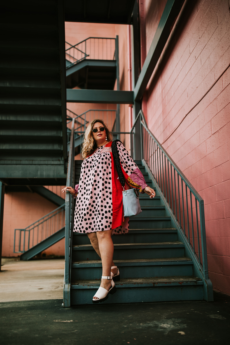 Atlanta Blogger-Influencer Photographer, Woman in pink polka dot dress walks down stairwell